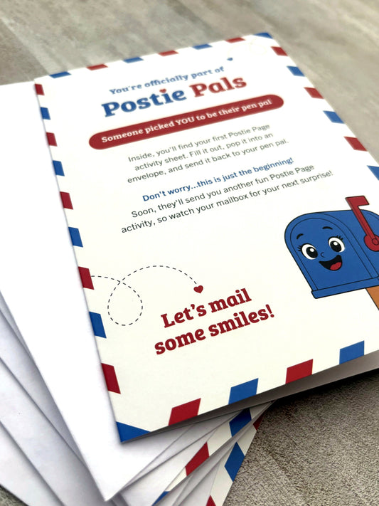 A stack of Postie Pals Starter Cards laid on a neutral textured surface. The top card has a cream background with red and blue border stripes, playful text, and a smiling blue mailbox illustration.